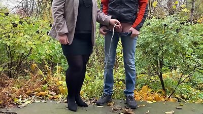 hot cougar in pantyhose and micro-skirt holding guy's jizz-shotgun outdoors while pissing